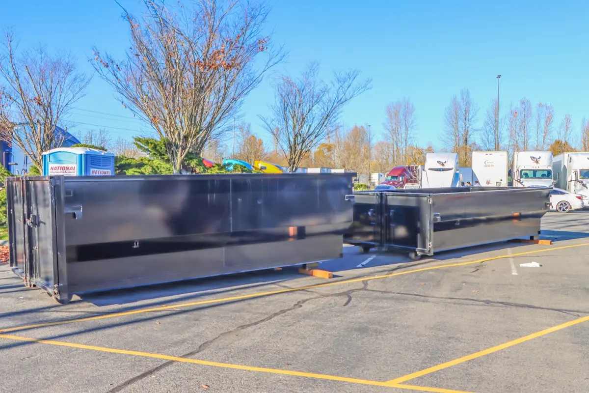 Professional dumpster rental service with roll-off container on residential driveway in Ross